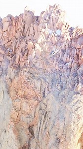 R66 Turbine hovers over a stunning mountain peak in South Patagonia. | Robinson Helicopter Company