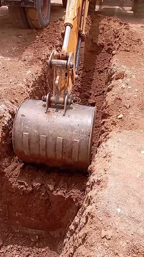 Excavator Operations: Digging a Trench at Construction Site