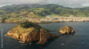 Islet of Vila Franca do Campo, Azores, Portugal. Beautiful coast with a settlement by the Atlantic Ocean. An exciting scenery of small island with the larger one behind. High quality 4k footage