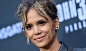 Halle Berry walks along the beach in tiny black bikini
