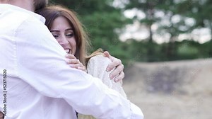 Couple laying with each other in the forest.