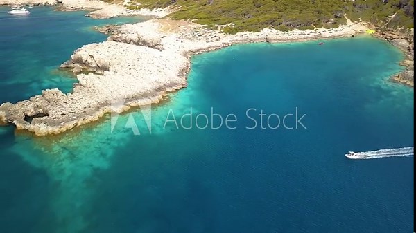 Italy, July 2022: Aerial view in 4K of the Tremiti islands in Puglia with n Caribbean sea, cliffs and boats off the coast