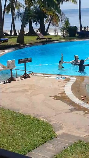 Pool fun time: Guests doing pool gymnastics at Neptune Beach Resort: #neptunehotels #magicalkenya #neptunebeachresort #beach vacation # www.neptunehotels.com | Neptune Hotels