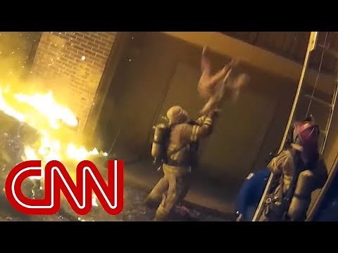 Firefighter catches child tossed from burning building