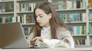 Teenage girl using computer at the library