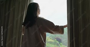 Woman wake up at morning and open the curtain at hotel room Видео Stock