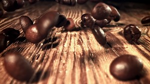 Coffee beans are falling. Macro shot. Filmed on a high-speed camera at 1000 fps. High quality FullHD footage