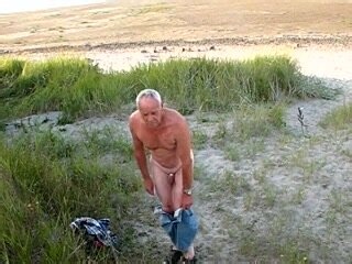 old man strips naked at the beach