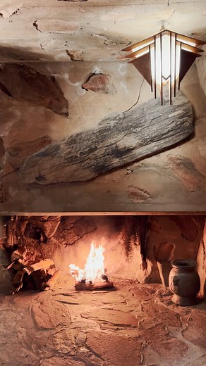 A glowing fire in the fireplace at Taliesin West during Home For The Holidays program with the sounds of cartoon music filling the air making the season bright. | Frank Lloyd Wright Foundation