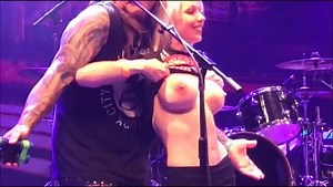 Tits out on stage, flashing them for the guys.