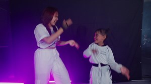 Dance performance with adult and child in white outfits