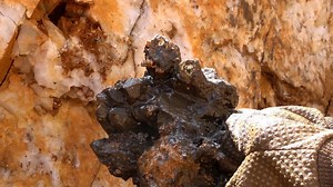 Team member Raymond pulls one amazing piece after another from a manganese-rich pocket of quartz as it slowly fills with water! | Avant Mining LLC
