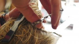 clip-1084466041-blonde-hair-woman-getting-dressed-salon-male