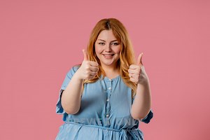 Happy Woman Gives Thumbs Up Like Gesture With Excitement And Expressive Approval - Stock Photos