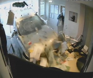 CCTV shows ex-cop ramming funeral parlour
