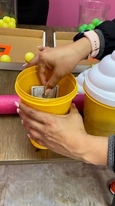 Prize game where girls have to get ping pong balls through a small hole to win cash and mystery prizes | Doug and Friends