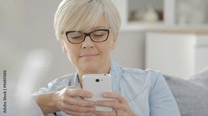 Senior woman with eyeglasses sending text message Stock Video