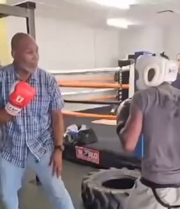 Former Heavyweight Champion Lennox Lewis showing a young fighter some tricks of the trade. | GYGB