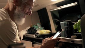 Happy Old Man Traveler Sitting in Camper Van Using Mobile in Camping at Night. Stock Footage - Video of online, nature: 278052636