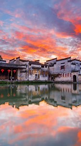 6.5K views · 41 reactions | BREATHTAKING dawn at China's ancient gems!  #Huangshan's UNESCO villages #Xidi & #Hongcun glow crimson, their white-walled #Huizhou architecture blazing under fiery clouds. Like stepping into a 1000-year-old ink painting ️ #China #Travel #CulturalHeritage | FlyOverChina | Facebook