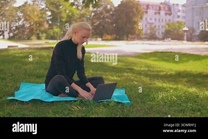 blonde girl works outdoors Stock Video Footage - Alamy