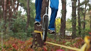 Extreme balance unicycle is riding on a tight rope or slackline