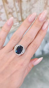 💙 Discover the Pinnacle of Elegance with Our Royal Blue Sapphire Ring 💙 Introducing a ring that redefines sophistication—a stunning 6.41 carat cushion-shaped blue sapphire, renowned for its vivid "Royal Blue" hue and exceptional clarity. Certified and sourced from the heart of West Africa, this sapphire's dimensions of 13.68 x 9.41 x 5.30 mm showcase its mesmerizing brilliance. The ring is artfully crafted in 18K white gold and adorned with a dazzling array of 74 diamonds: 2 half-moon shaped d