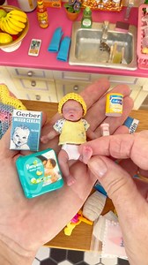 Any Weekend plans. I need to clean my toys up & 🫧🧽🧼🧹 put my messy-ness in order. 💖 Saturday morning cuteness overload! 🍼 The tiny Gerber box and Pampers package get me every time! 😍 I have so much fun collecting these 1:6 scale nursery items. ✨ #miniaturecollector #dollhouseminiatures #tinythings #miniaturelife #dollhouse #onesixthscale | Grandma Gets Real