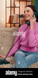 Young woman at home talking and laughing happily on vintage retro 90s telephone receiving good news. Caucasian girl on sofa joyful communication, excited emotional reaction, positive smiling Stock Video Footage - Alamy