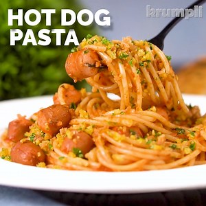Hot dog pasta is a playful recipe that pairs spaghetti with frankfurters in a tomato sauce, topped with mustard breadcrumbs & crispy onions. It may all sound a bit silly, but it tastes delicious and is guaranteed to put a smile on the faces of young and old alike! | Krumpli - Eating In Should Be Special Too