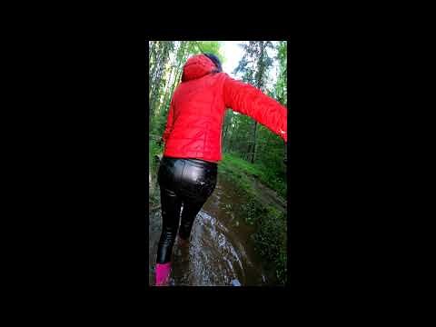 Wet rubber boots and wet leather pants in mud