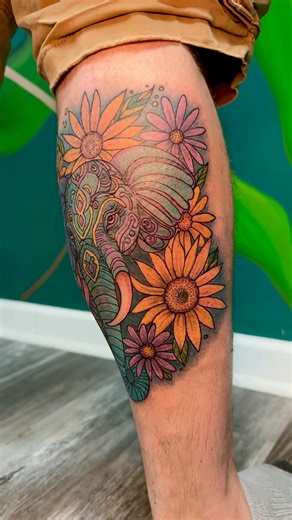 A symbol of love, strength, and patience 🐘💛 This colorful elephant and floral piece was done in honor of his wife who love elephants and🌻 flowers— and he sat like an absolute champ through one of the toughest spots! | Amber Nichole Tattoos