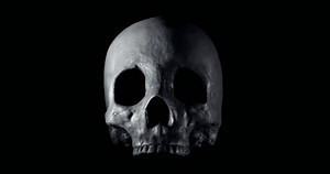 Terrifying human skull, haunted spirt, or frightening ghost slowly creeping forward for Halloween or other spooky scene.