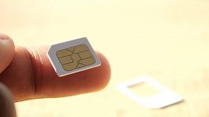 A sim card for a smart phone on finger