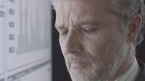 Focused mature investor analyzing financial trading charts | Free Stock Video Footage