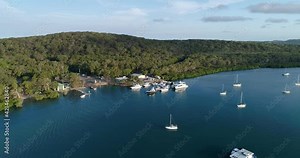 Reverse tracking aerial view of the marina and boats in river outlet at the town of Seventeen Seventy,Queensland,Australia