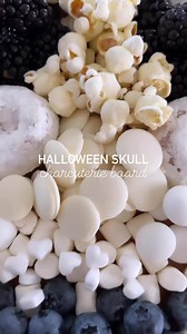 Create a spooky Halloween charcuterie board skull centerpiece with this dessert tray, paired with ghoulish snacks for a chillingly delicious soirée. Ingredients: Blackberries Blueberries White chocolate dipped pretzels White chocolate chips Mints Mini marshmallows White cheddar popcorn Mini donuts Find more fun food @homemade.heather 💀 | Homemade Heather