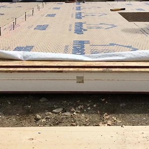 “How do you install the wiring?” The SIPs have a grid of vertical and horizontal wire chases. After assembling a wall section we spray expanding foam into predrilled holes at the seams which can expand into the wire chase. Here we are teaming the chases to remove the expanding foam. #shelterinstitute #shelterdesignbuild #timberframe #thinkbuildlive #sips #structuralinsulatedpanels | Shelter Institute