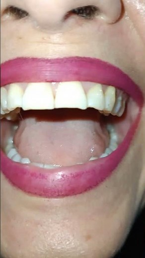 A woman’s smile with gorgeous lips and raspberry lipstick.