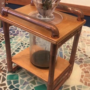 Good morning, #Dalgona! Your concentrated #espresso is drip distilling nicely, we’re getting ready for you ☕️🧊🥛 Josh is working on his #copperfurniture display too, this pour over station he built is a good stand-in. It involves cutting beautiful blue bottles and figuring out the perfect lid. #makersgonnamake | Bazaar Cafe