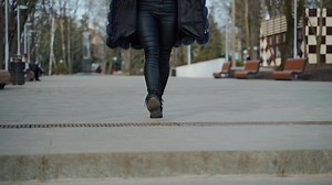 Beautiful woman walking in park. Close up of woman in casual clothes posing outdoors