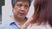 Angry old woman disagrees with annoyed young daughter, grown daughter...