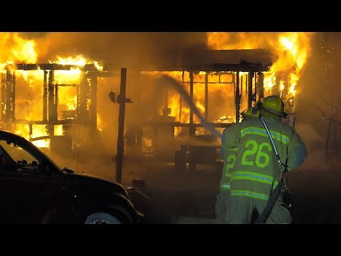 PRE-ARRIVAL: Firefighters arrive to find this trailer home fully-involved with 2nd home on fire