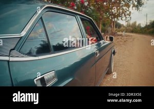 Focused Woman Driving Classic Car Closeup Of Hands On Steering Wheel, Striped Blouse, Red Headscarf, Floral