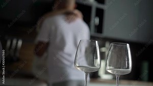 Young couple passion at the kitchen. Man and woman hugging at counter and kissing