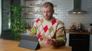 clip-3425301487-adult-man-enter-credit-card-number-on