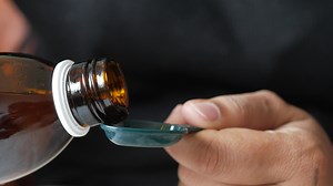 cough syrup pouring from a bottle