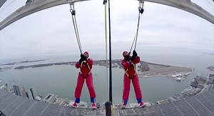 Harlem Globetrotters Zeus and El Gato scope out a trick shot high above Toronto from the iconic CN Tower Walk. | Toronto Sun