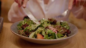 Female eating out healthy salad keeping track of balanced food.