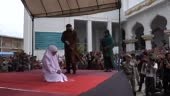 An acehnese woman gets caning in public from an executor known as...